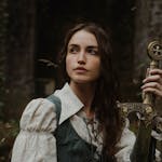 Portrait of a woman with a medieval look, holding a sword in an outdoor setting, exuding strength and elegance.